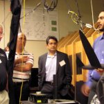 Ph.D. candidate, Yohanna Hanna (right), describes his experimental work, currently in progress in the Dryden Wind Tunnel, to members of the Society of Experimental Test Pilots